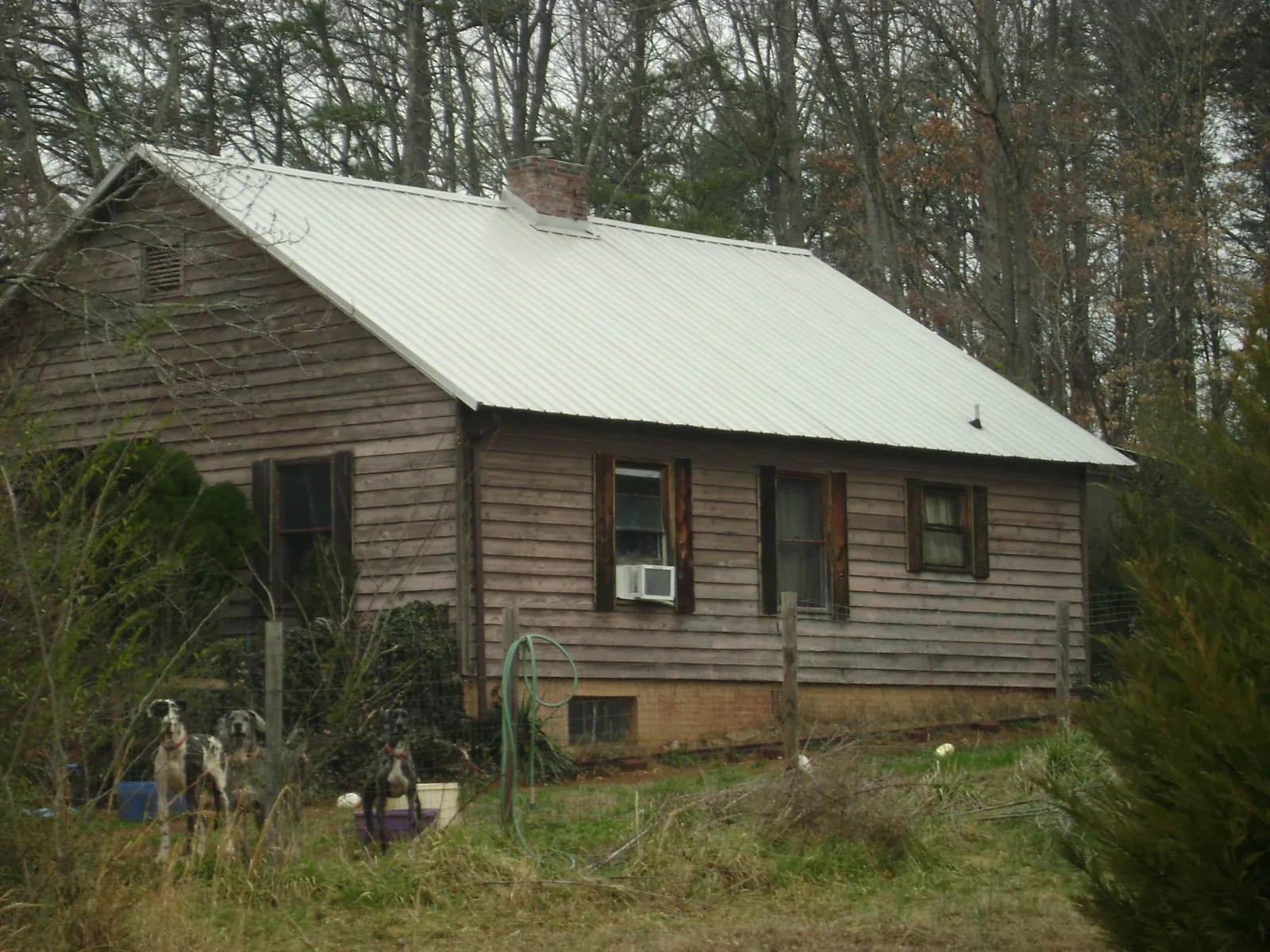 White metal roof on an old wood sided farmhouse, from a Metal Roof Installation job in Shelbyville